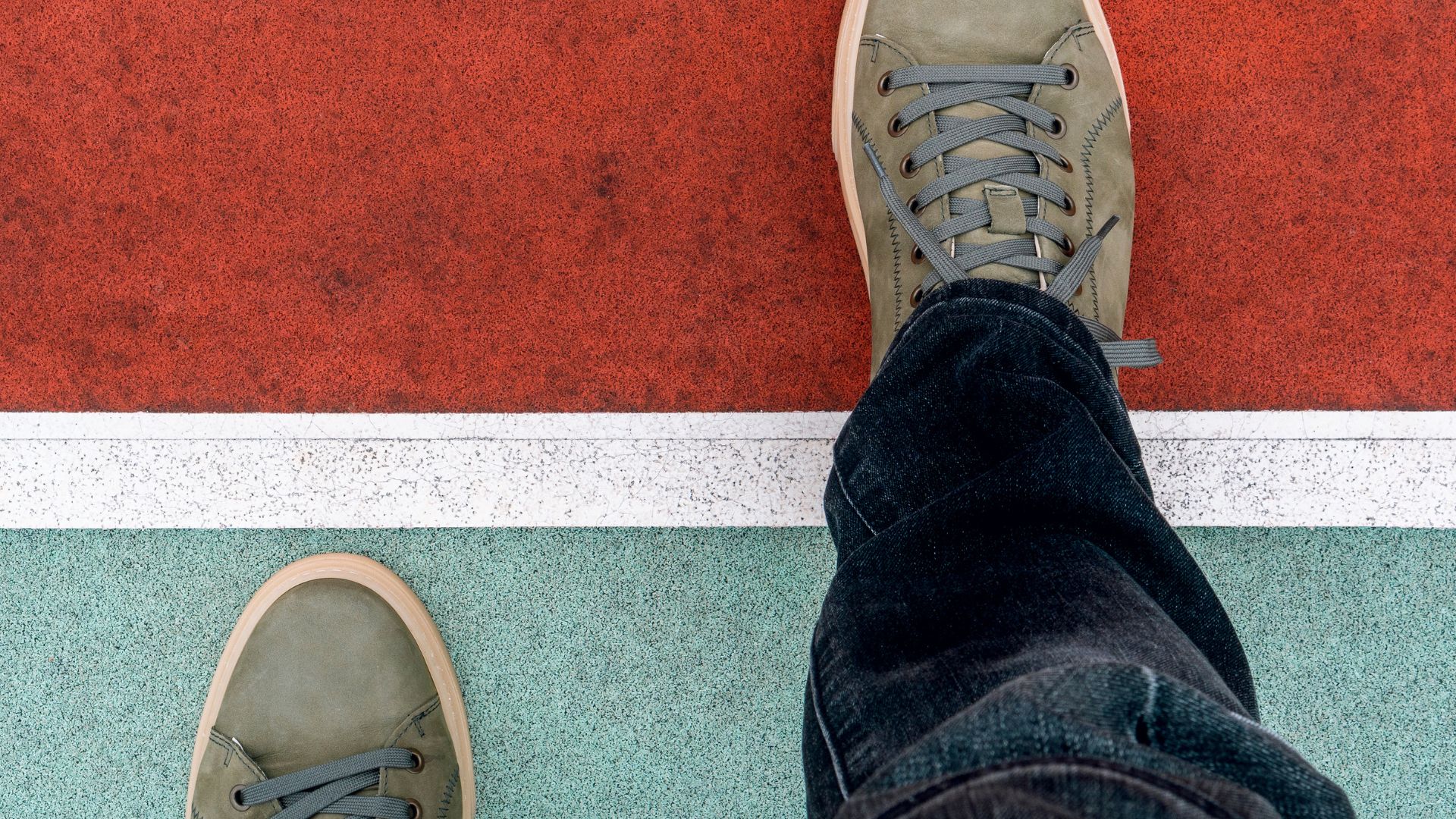 Person stepping over a painted line on the ground, symbolizing a step toward recovery