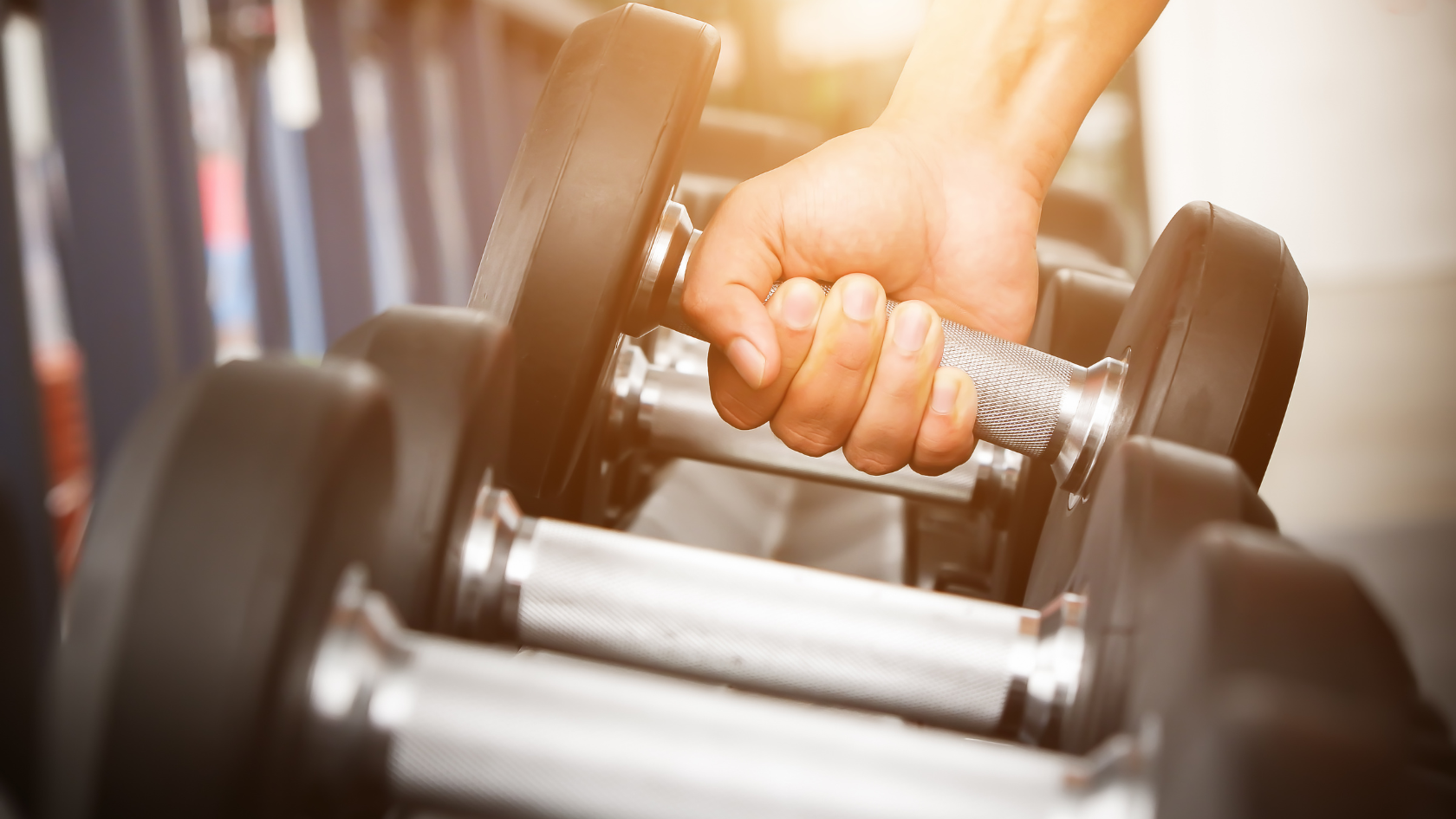Hand gripping a dumbbell