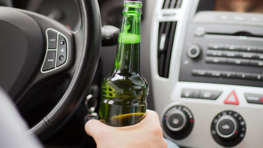 Man drinking a beer while driving