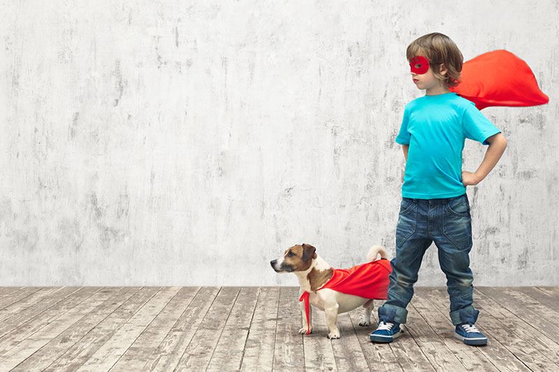 Young boy with his dog (both in superhero costumes)